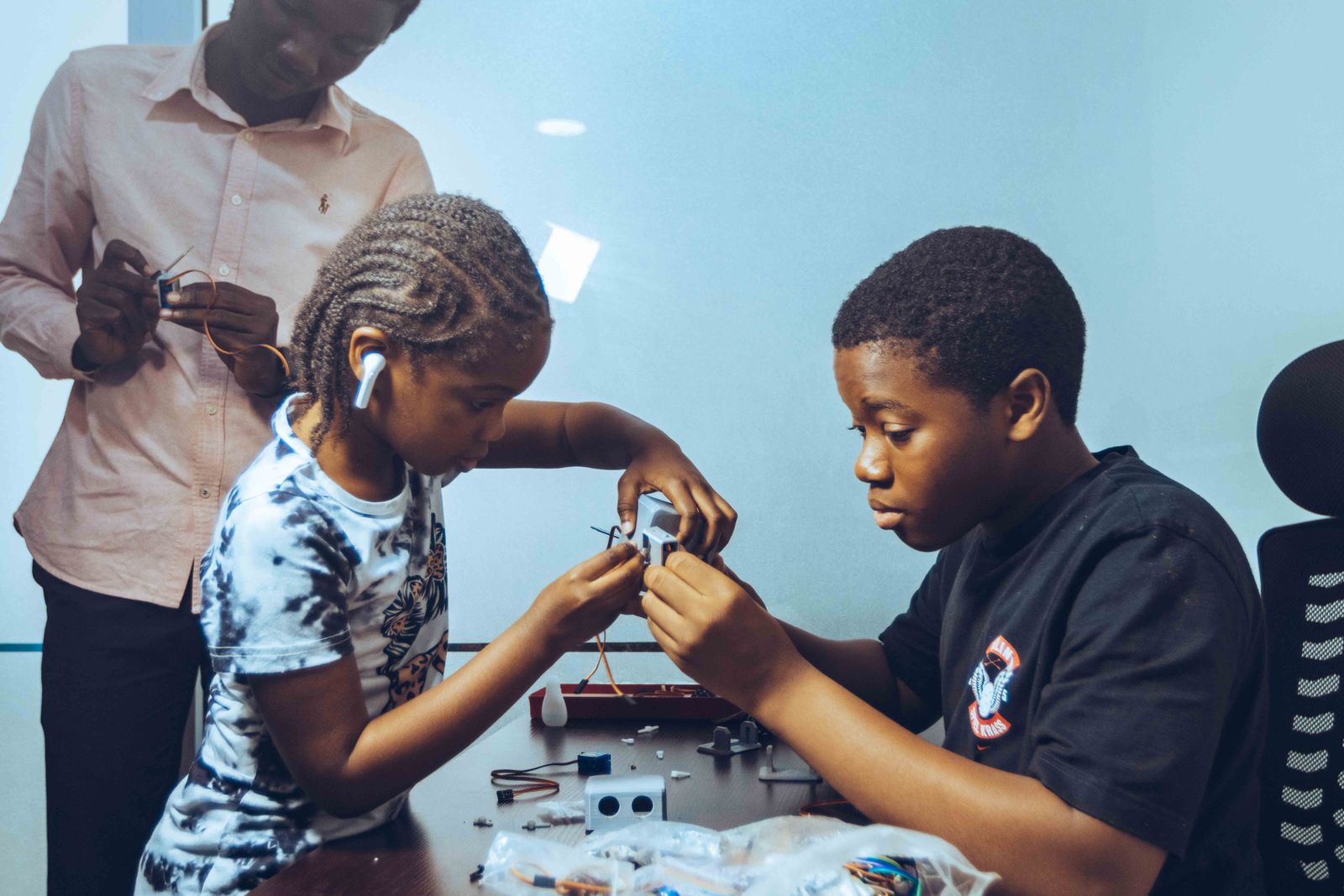 Technology students collaborating on an electronics project in Accra