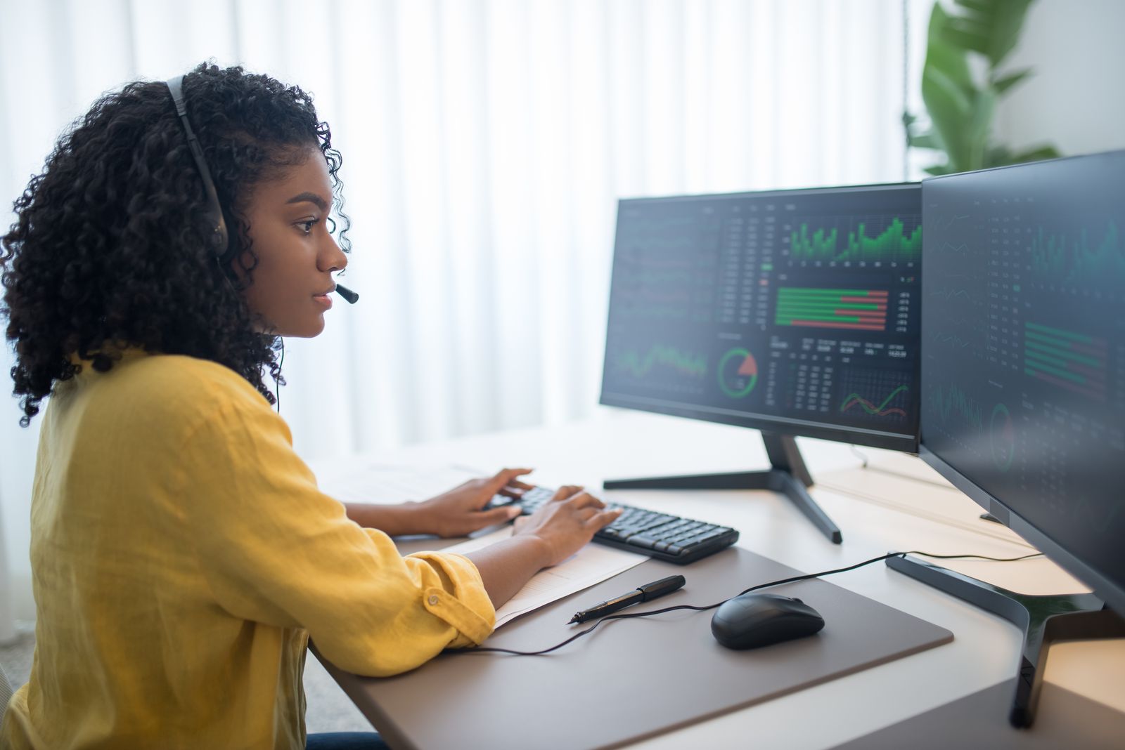 Security analyst reviewing live monitoring data across multiple displays
